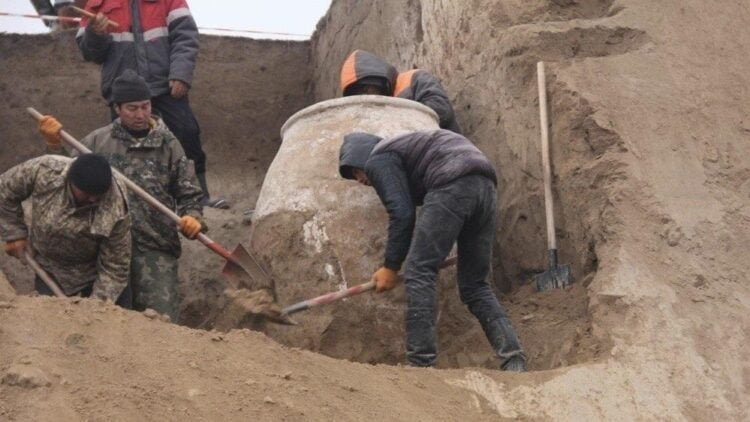 Archaeologists unearth a large clay vessel in Kyrgyzstan